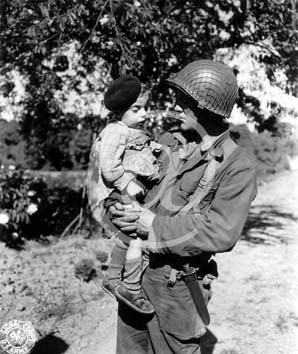 TREVIERES(14710) Seconde guerre mondiale Un soldat amricain tient un enfant dans ses bras.